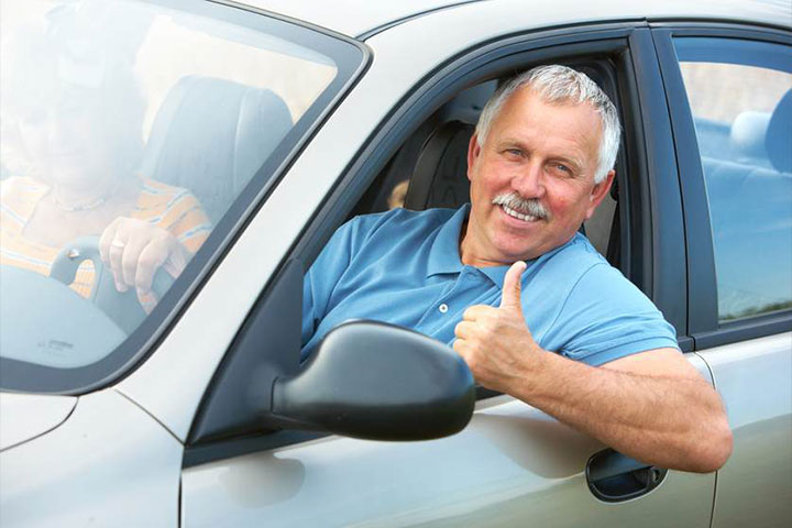 Man in Car giving a Thumbs Up as an auto driver